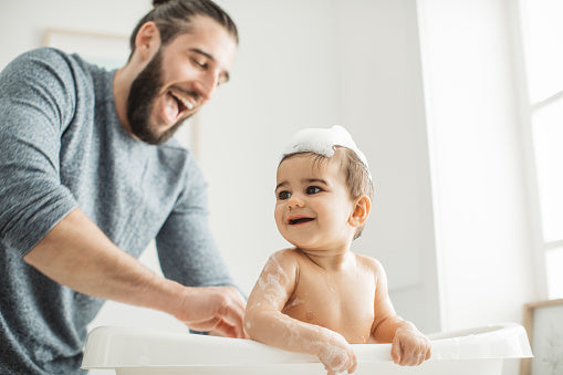 parent giving baby a peaceful bonding bath