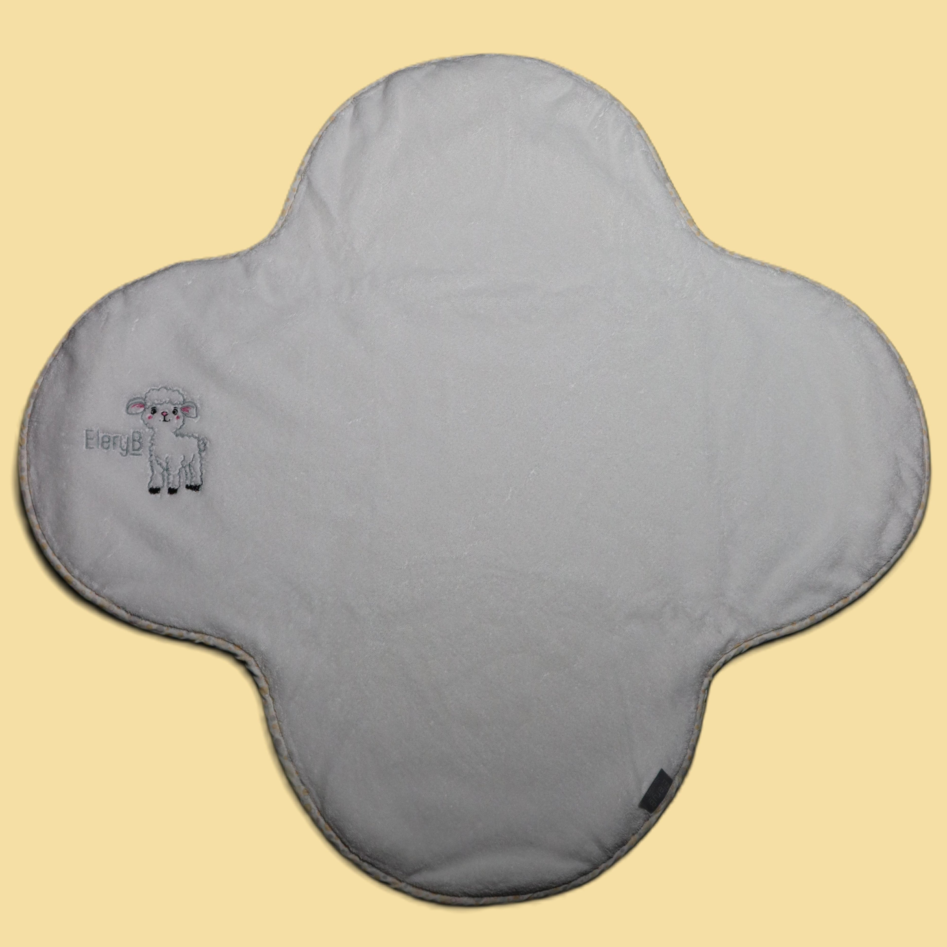 White EleryB towel with yellow geometric trim and embroidered lamb logo, full view

