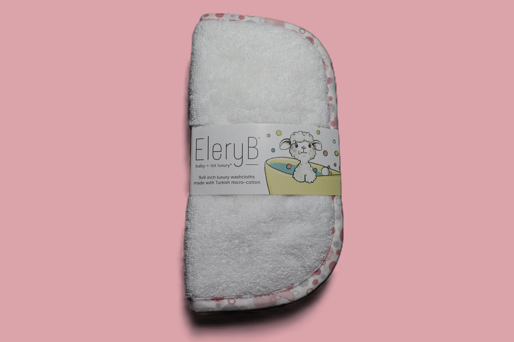 Three EleryB hypoallergenic washcloths with pink trim bundled in logo bellyband
